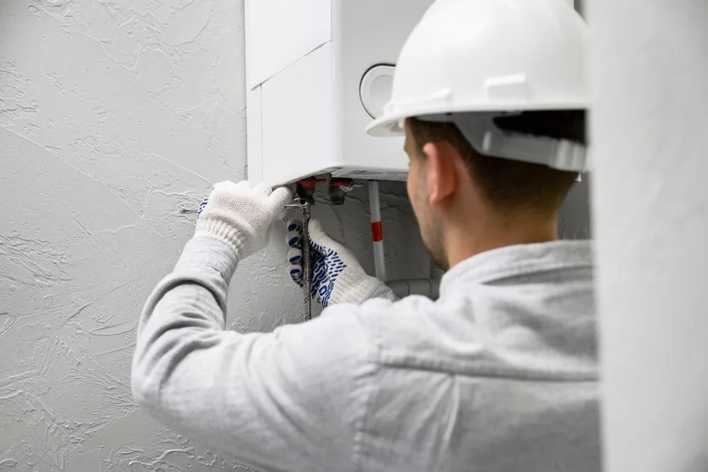 Wall-mounted tankless water heater unit installed in a Philadelphia home utility area