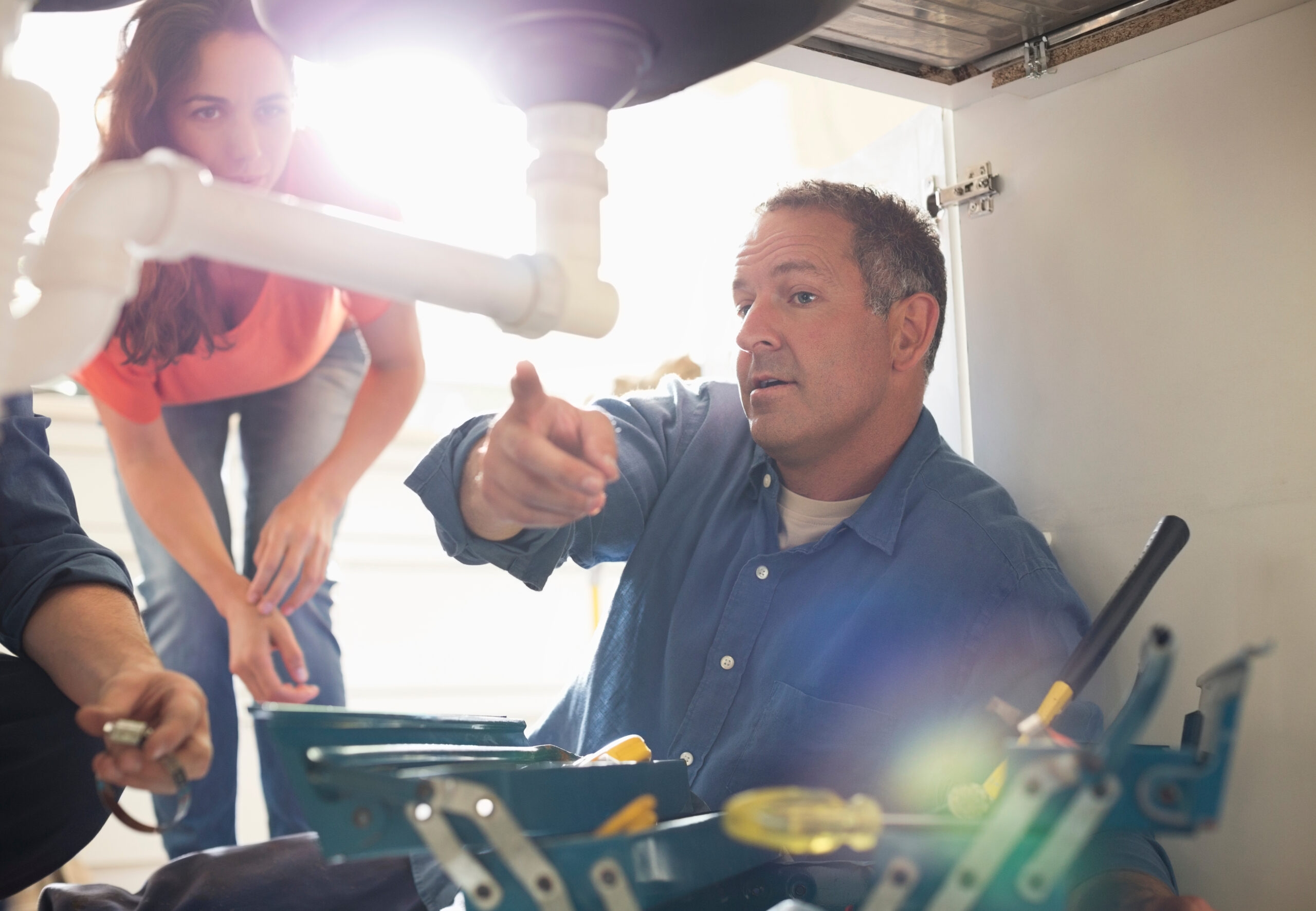 a workger pulling tools out of a Guaranteed Plumbing van