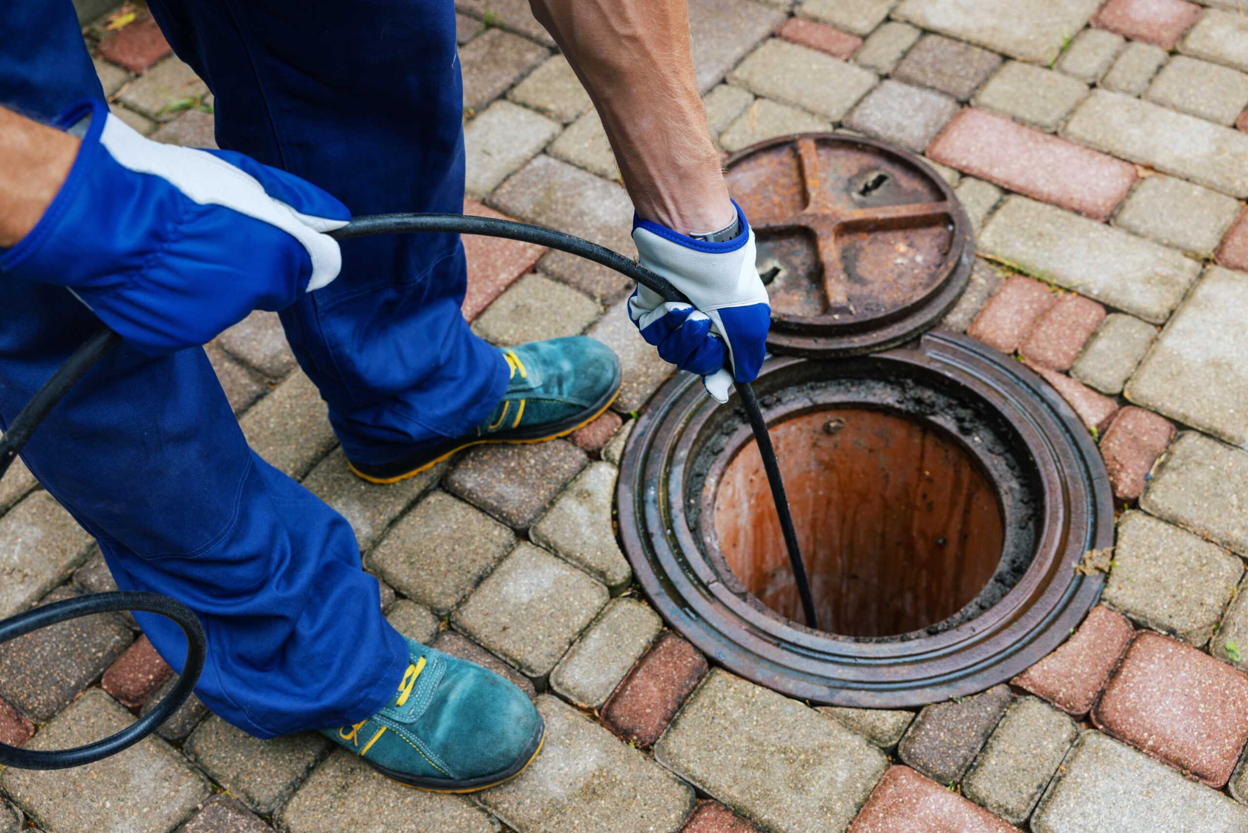 a workger pulling tools out of a Guaranteed Plumbing van